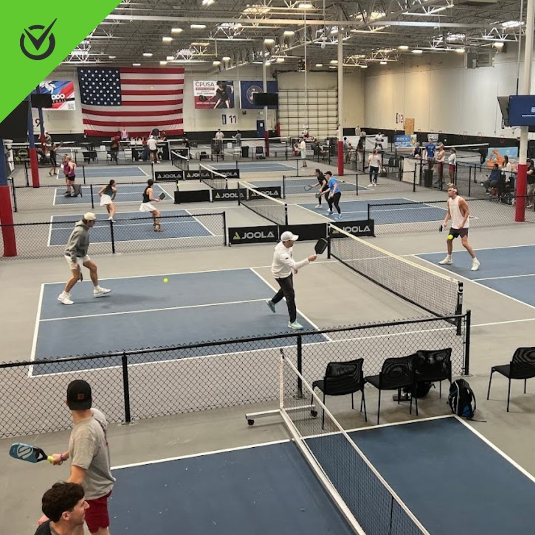 Photo of Club Pickleball USA’s indoor courts with players mid-game