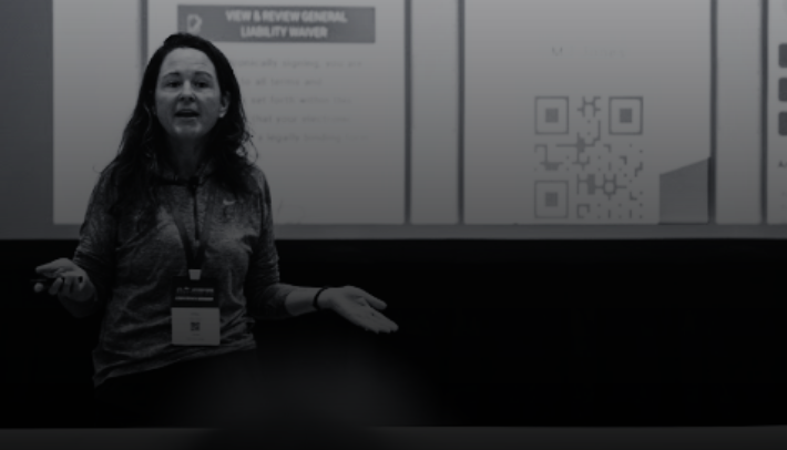 Woman presenting with slides in background