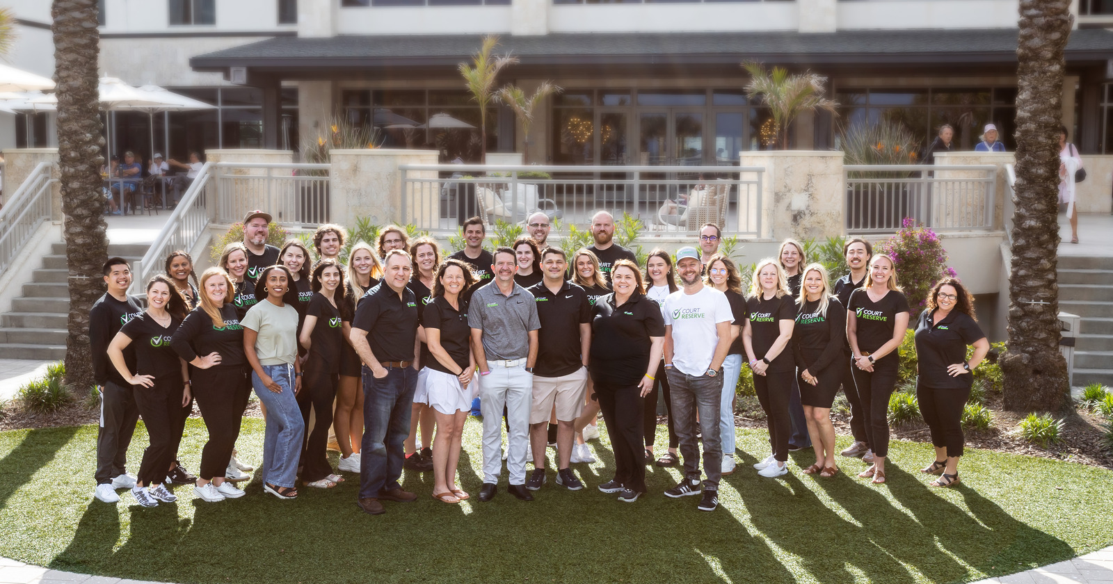 Group of people posing outdoors in front of a building