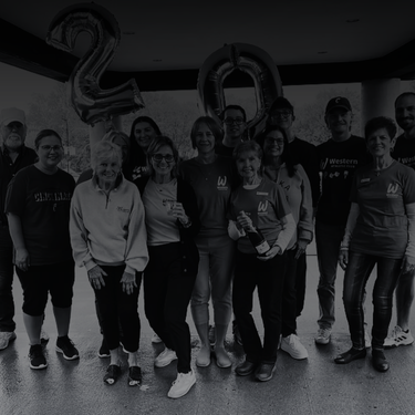 Angela Wilson Group of people celebrating with silver number balloons