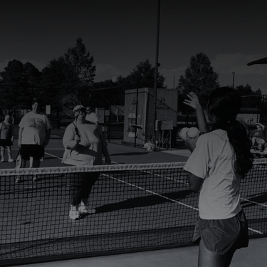 Pat Malone People playing pickleball on outdoor court