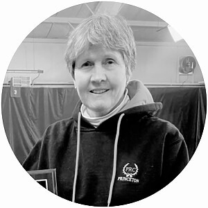 Person in hoodie with PRC Princeton logo, indoor setting