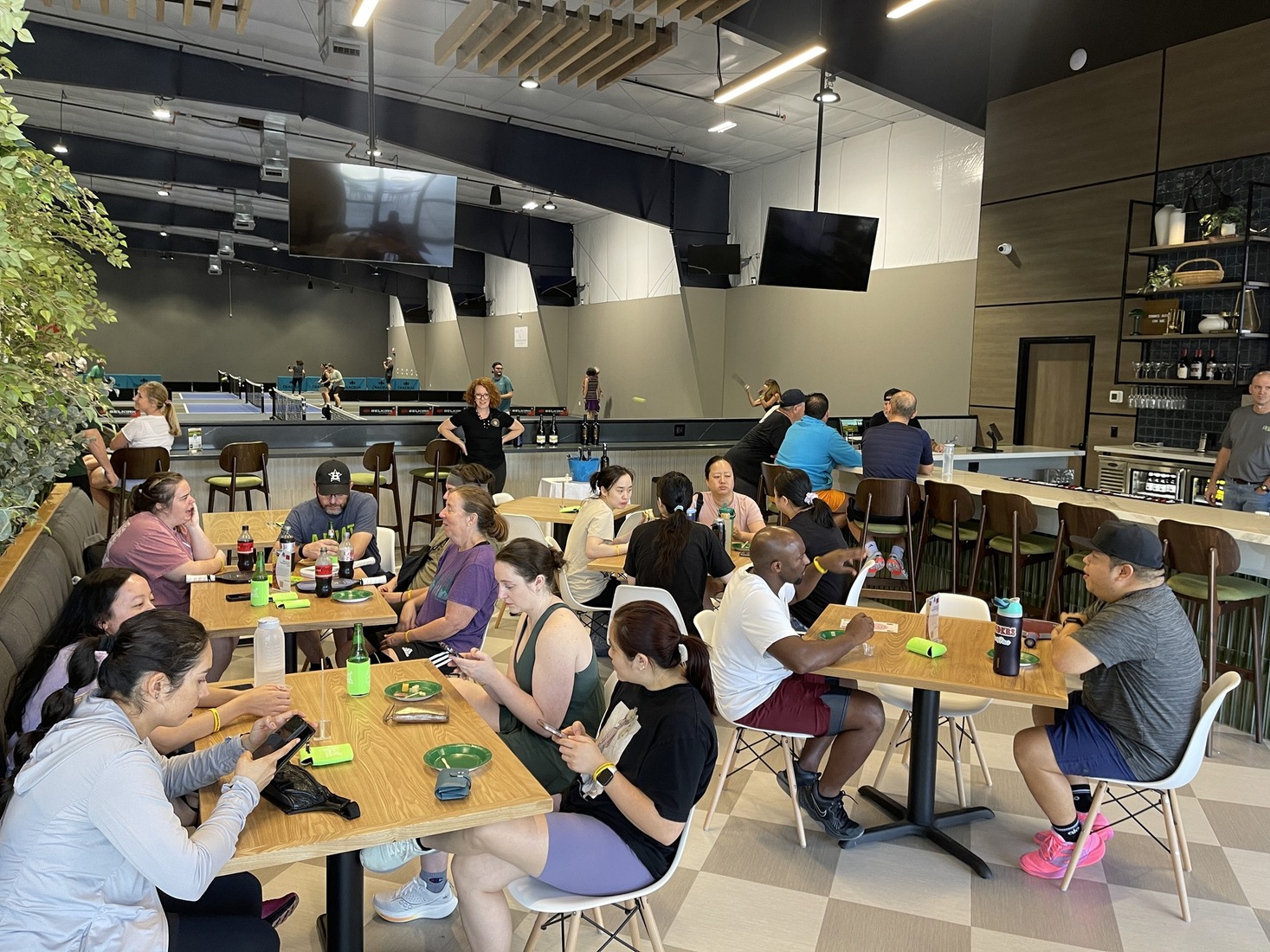 Pickleball Zone's bar area packed with people on opening day.
