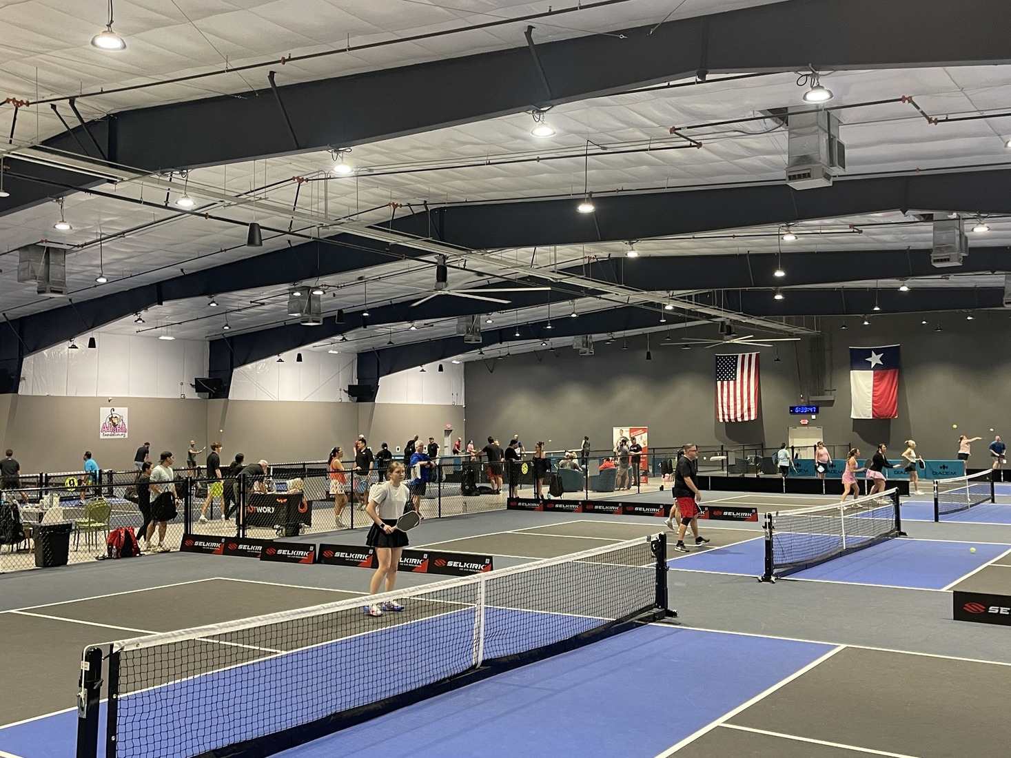 Pickleball Zone's pickleball courts filled with players in games.
