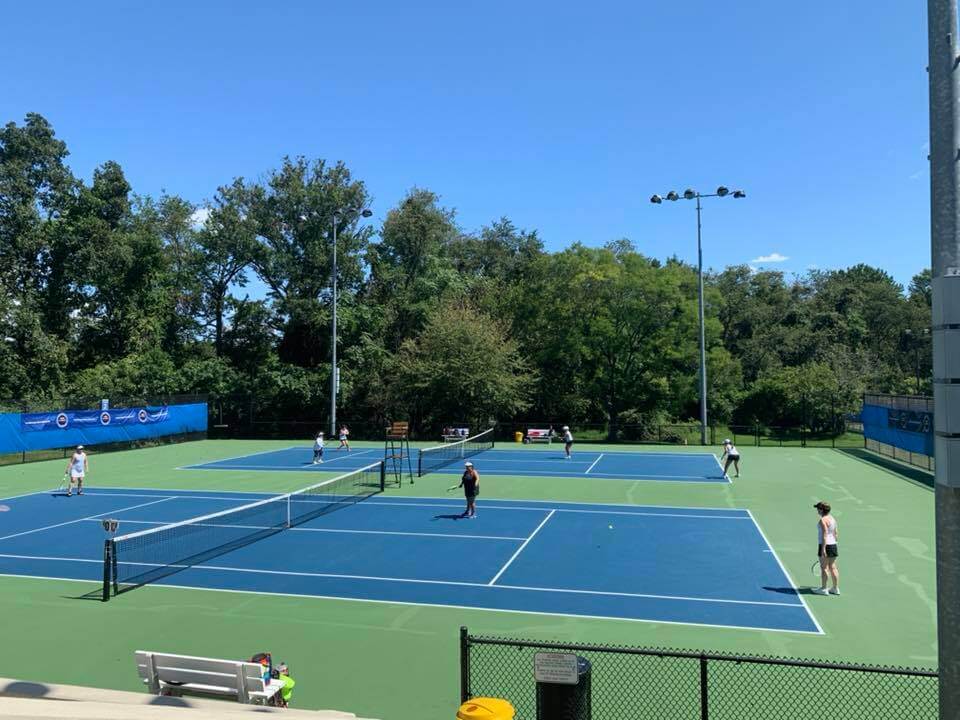 PRC's outdoor courts with players during sunny day