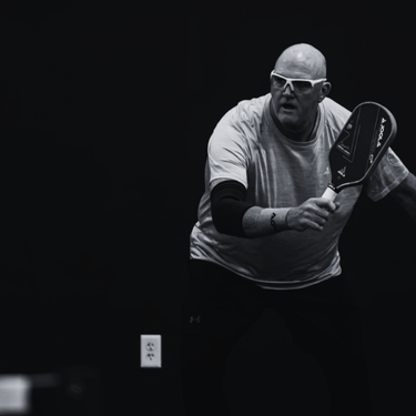 Jeff Kinlaw - PPR Instructor & Player Black and white action photo of pickleball player, Jeff Kinlaw.