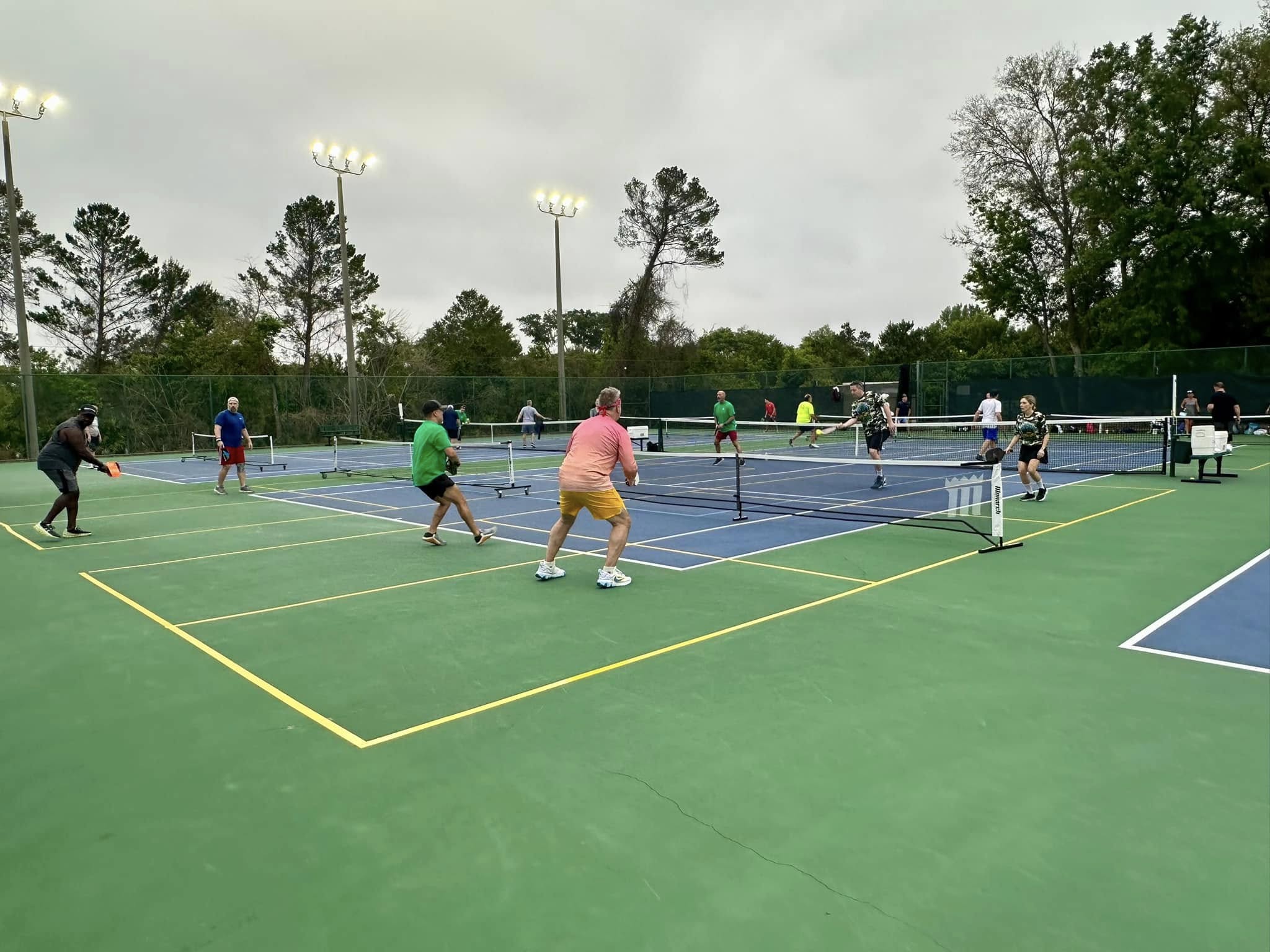 Players mid game at Lake Cane Tennis Center