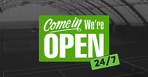 Green sign with bold white text that says ‘Come in, We’re OPEN’ with an additional green tag reading ‘24/7,’ overlaid on a background of indoor tennis courts.