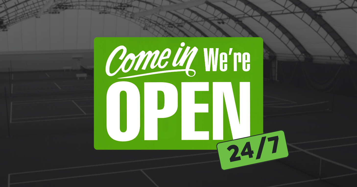 Green sign with bold white text that says ‘Come in, We’re OPEN’ with an additional green tag reading ‘24/7,’ overlaid on a background of indoor tennis courts.