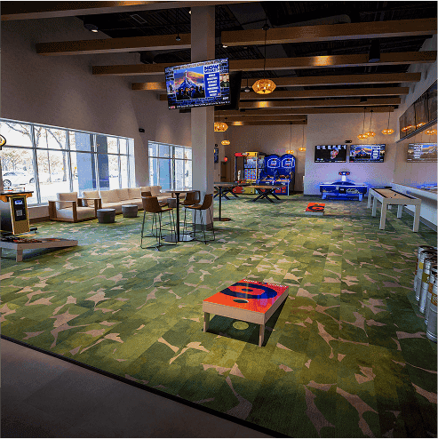 Arcade games and lounge area at Crush Yard