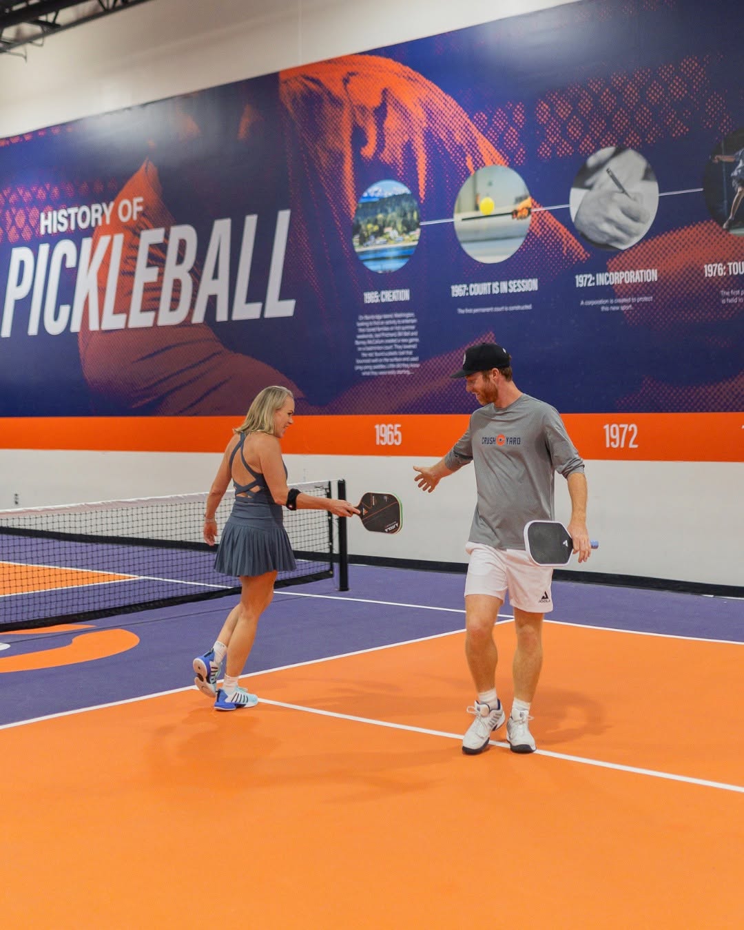 Two pickleball players on court at Crush Yard